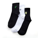Three socks with cactus, avocado and eye designs on