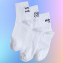 Three white socks with black text on top of the heel