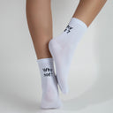 white socks with why not? black text on top of the heel