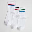 Three pairs of white socks with colorful stripes red-blue, red-black and green-blue.