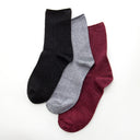 Three pairs of socks in black, gray, and burgundy glitter.